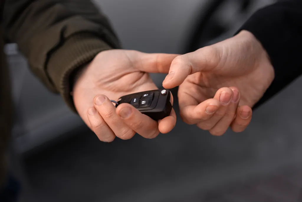 high-angle-hands-holding-car-key.jpg