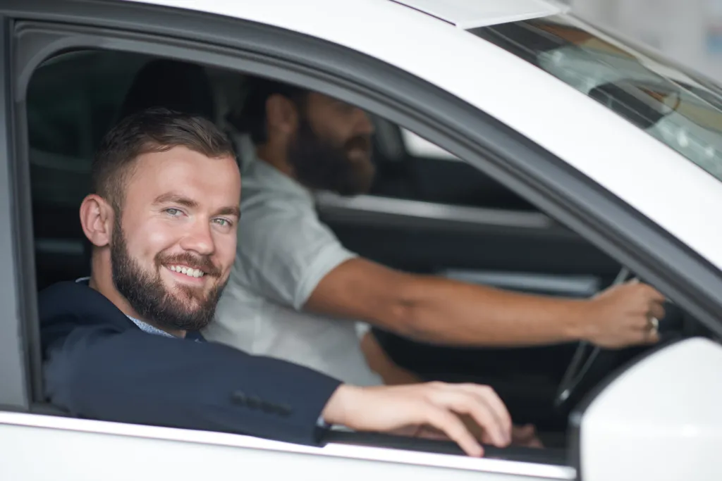 men-posing-car-cabin-car-dealership (1).jpg